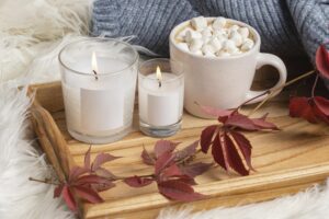 a tray with candles and a cup of hot chocolate